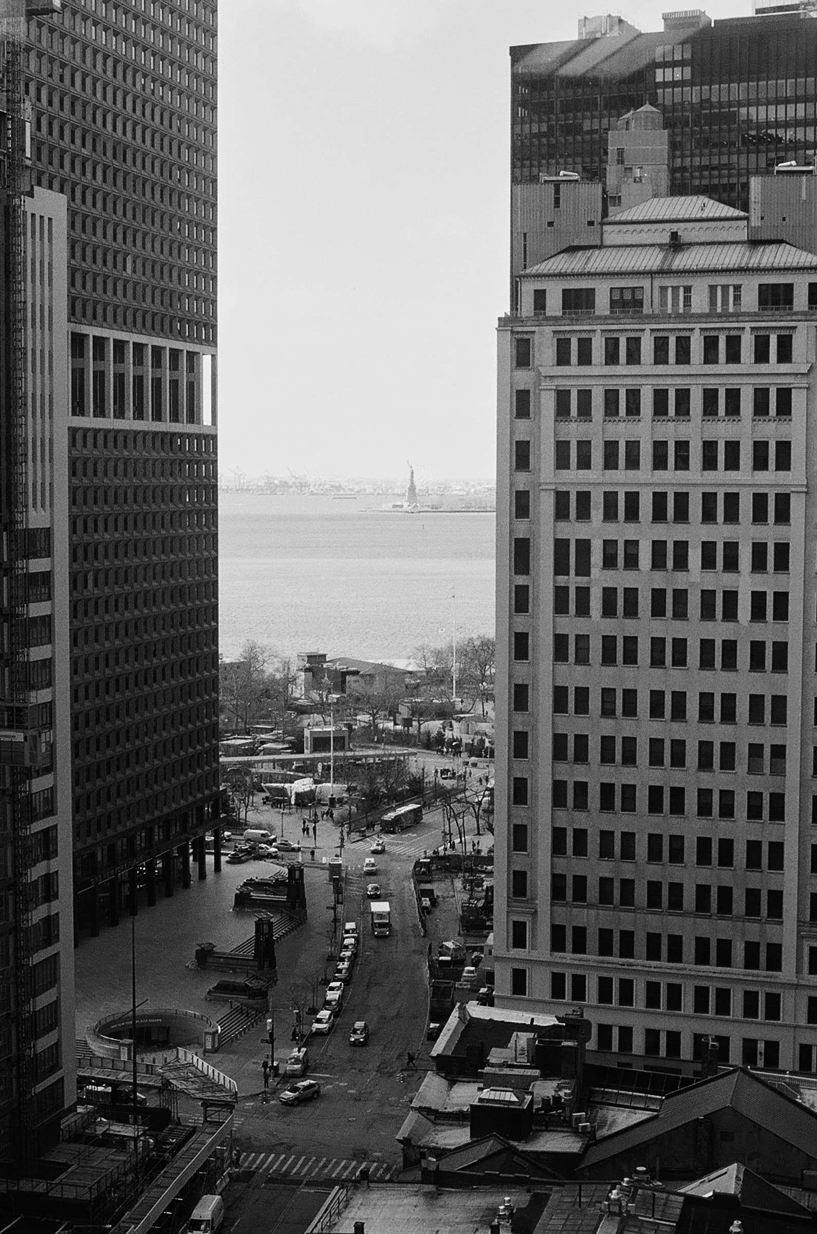 Shot of New York City from an office window, overlooking the Financial District with the Statue of Liberty in the distance