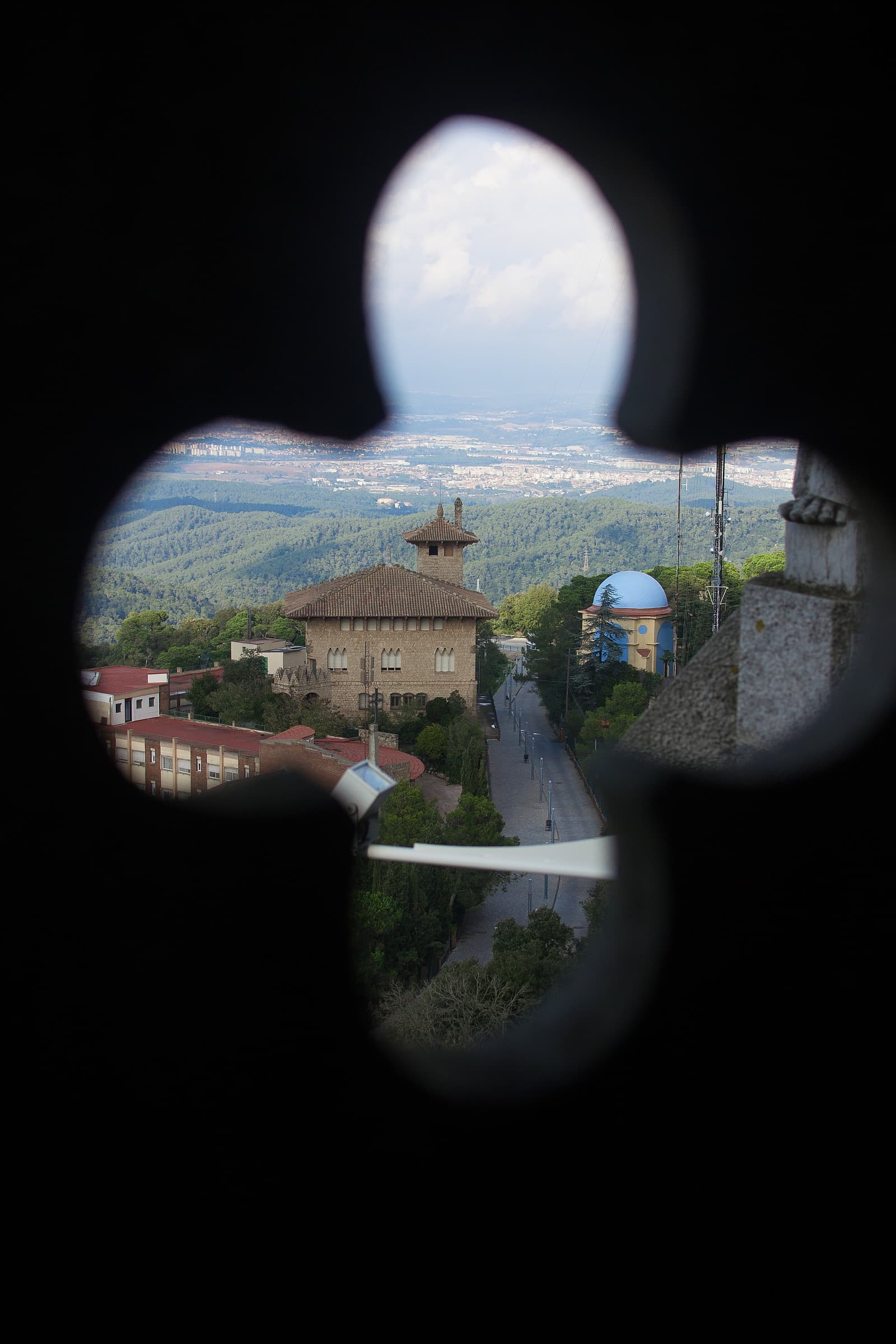 Photo of Barcelona viewed through a clover-shaped peephole