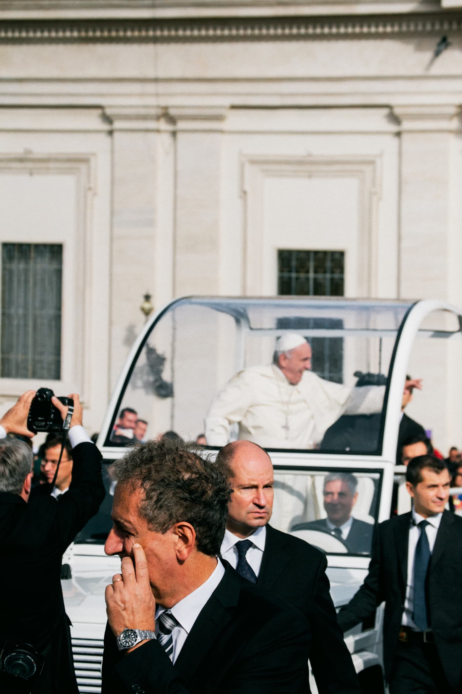 Photo of Pope Francis, accompanied by security, making his way to begin the papal Mass